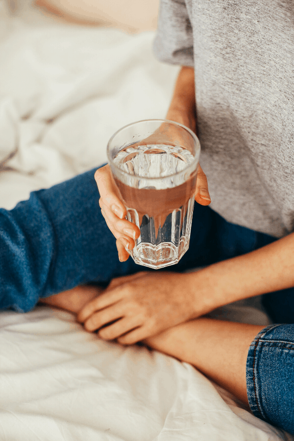 woman holding a glass of water