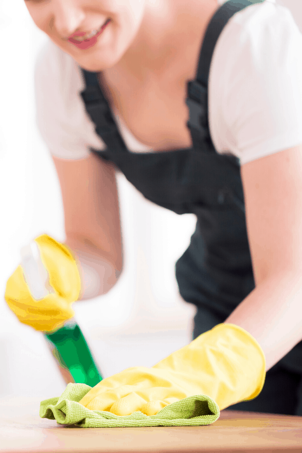 woman dusting surfaces