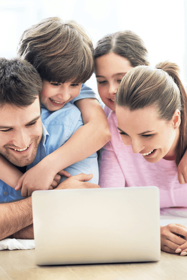 family crowded around a laptop