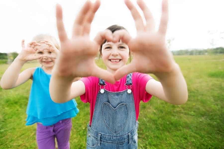 kids making a heart shape with their hands