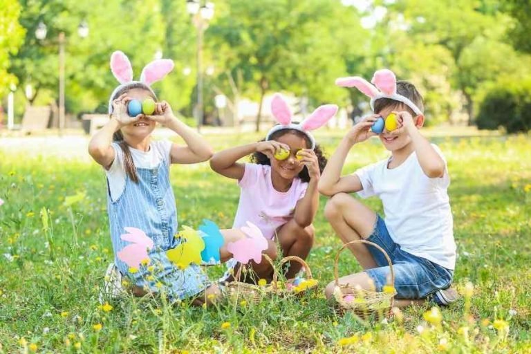 three kids hunting easter eggs